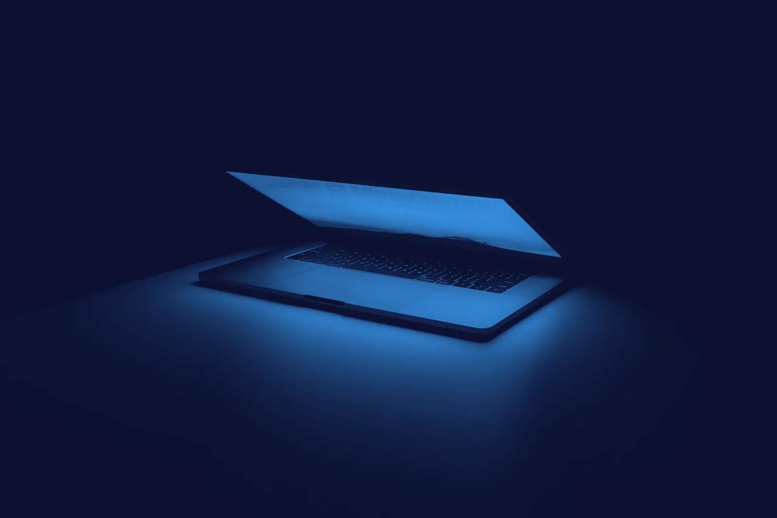 Duotone blue-tinted photograph of a desk with a laptop, smartphone and headphones, the daily hardware beat TechDailyBrief covers.